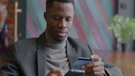 man paying with credit card in a cafe