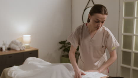 masseuse performing a relaxing back massage at a spa