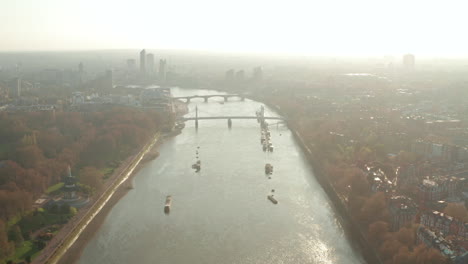 Descending-aerial-shot-over-river-Thames-Albert-and-Battersea-bridges