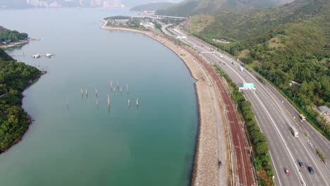 Hong-Kong-hidden-bay-in-Lantau-island-with-old-Tree-trunks-sticking-out-of-the-water,-Aerial-view