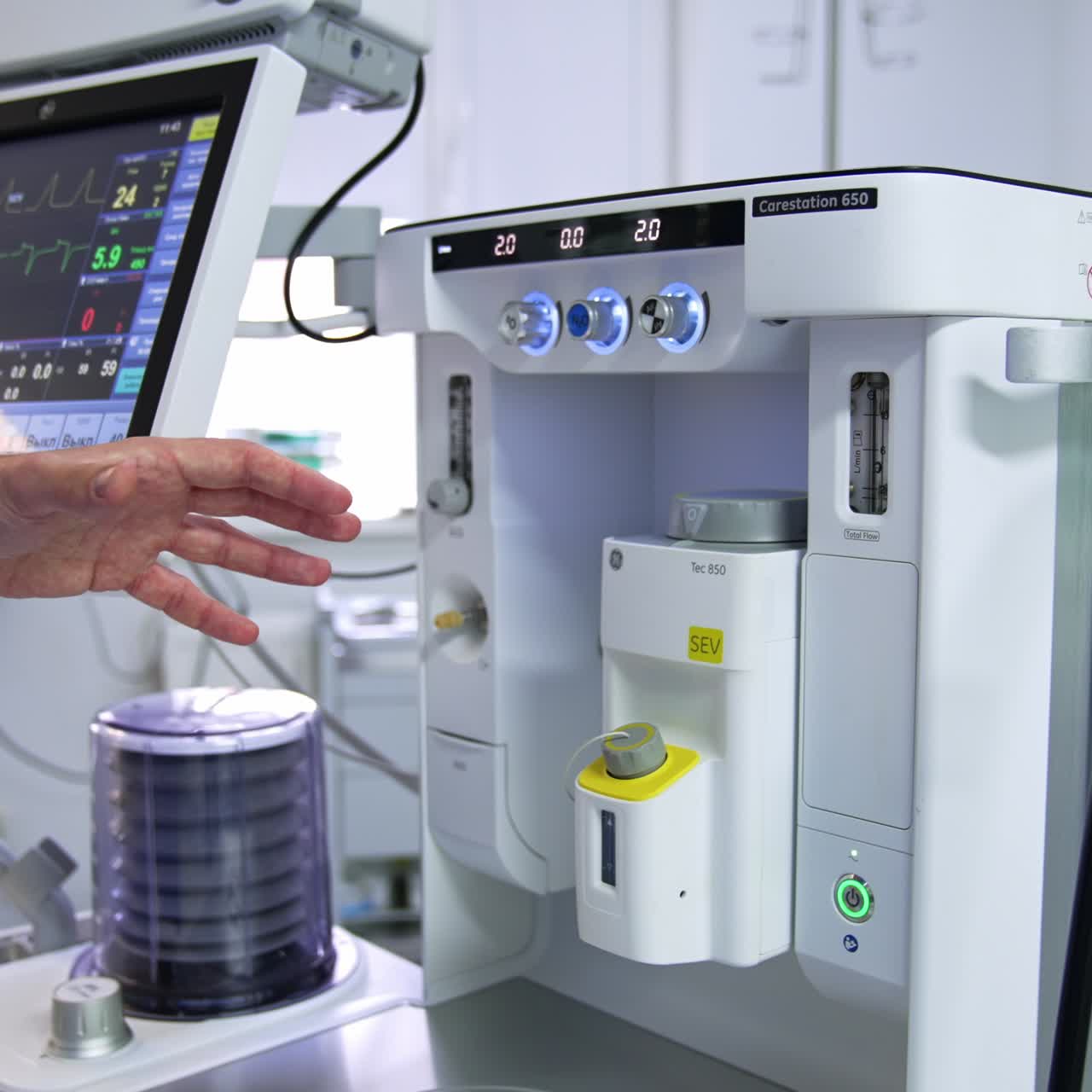 Modern advanced equipment ready for exploitation in the surgical practice. Male doctor's hand pointing at apparatus explaining its work