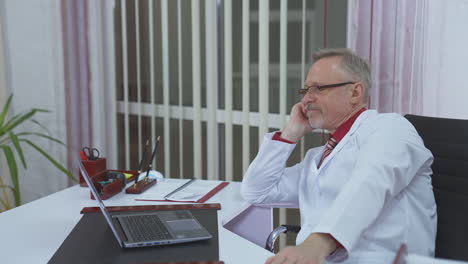 overworked doctor sitting in his office
