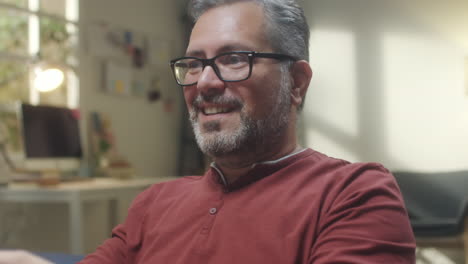 middle-aged man playing video games at home