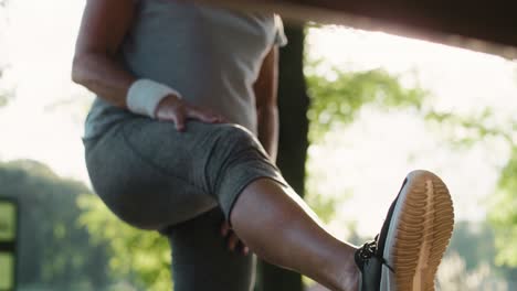 Senior-woman-stretching-in-the-park-on-bench