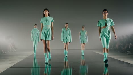high fashion runway showcase featuring elegant mint green attire, highlighting innovative designs and talented models during a striking contemporary fashion event