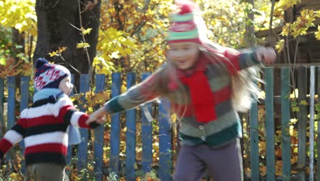 brother and sister playing in the countryside in autumn