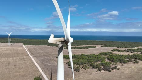 Stationary-drone-shot-of-spinning-wind-turbine