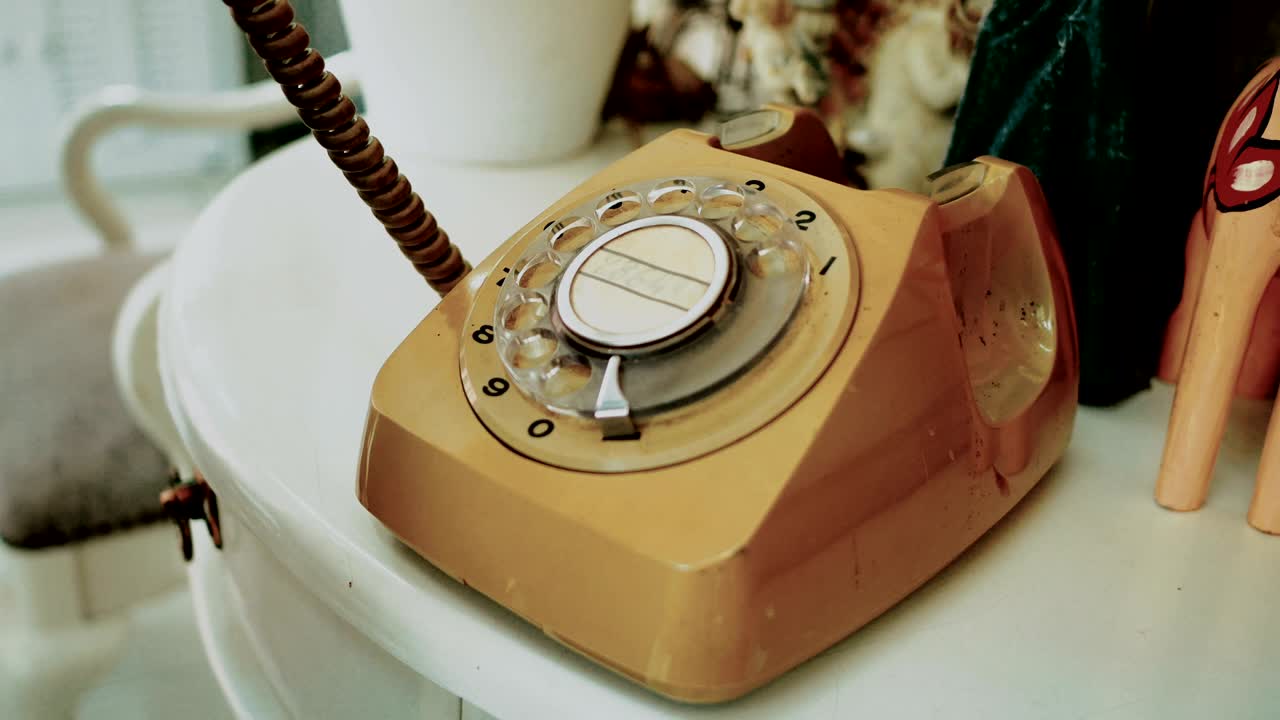 4k: 사람들이 손가락으로 전화를 걸고 레트로 로터리 빈티지 스타일의 전화. 빈티지 톤을위한 필름 염료. 오래된 통신 기술