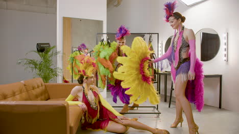 Three-Showgirls-Having-Fun-With-A-Feather-Fan