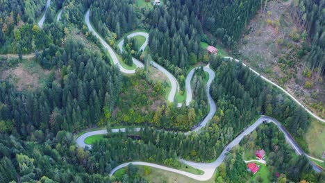 Winding-road-along-green-dense-forest,-Eisenkappel-Vellach,-Austria