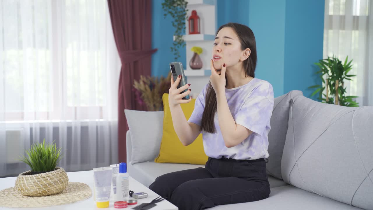 아시아 십대 소녀가 그녀의 피부와 얼굴 특징을 보고 있습니다.