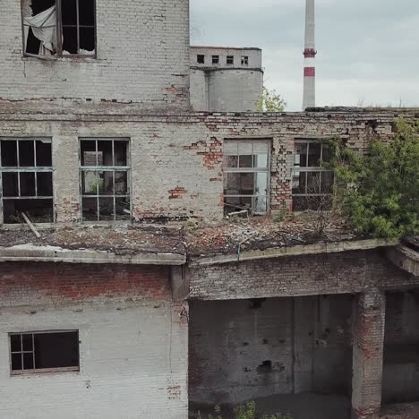 aerial view of abandoned industrial buildings. abandoned factory halls with broken glass on windows.