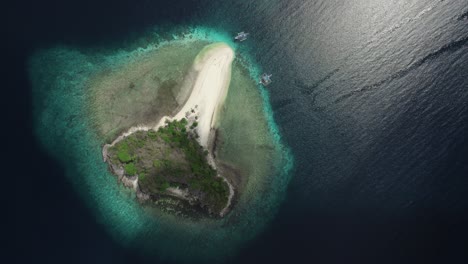 stunning aerial view of a pristine tropical island in the philippines, surrounded by crystal-clear ocean waters, showcasing natural beauty and tranquility