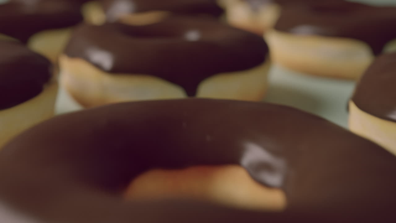Chocolate glaze donuts on a mint background