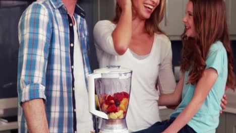 happy family making smoothie