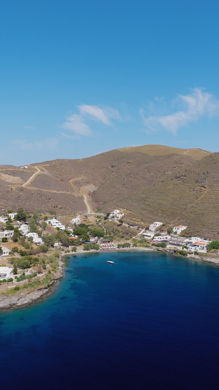 Martinakia port town beach, Kythnos island, Cyclades, drone shot, vertical