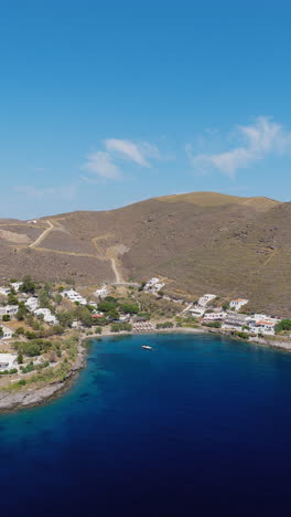 martinakia port town beach, kythnos island, cyclades, drone shot, vertical