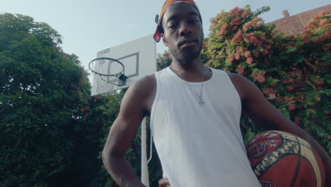 young black basketball player posing on camera on outdoor playground