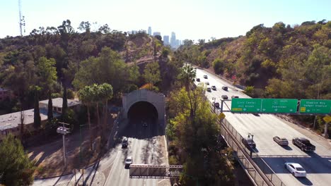 aerial freeway cars travel along the 110 freeway in los angeles through tunnels and towards downtown skyline 4