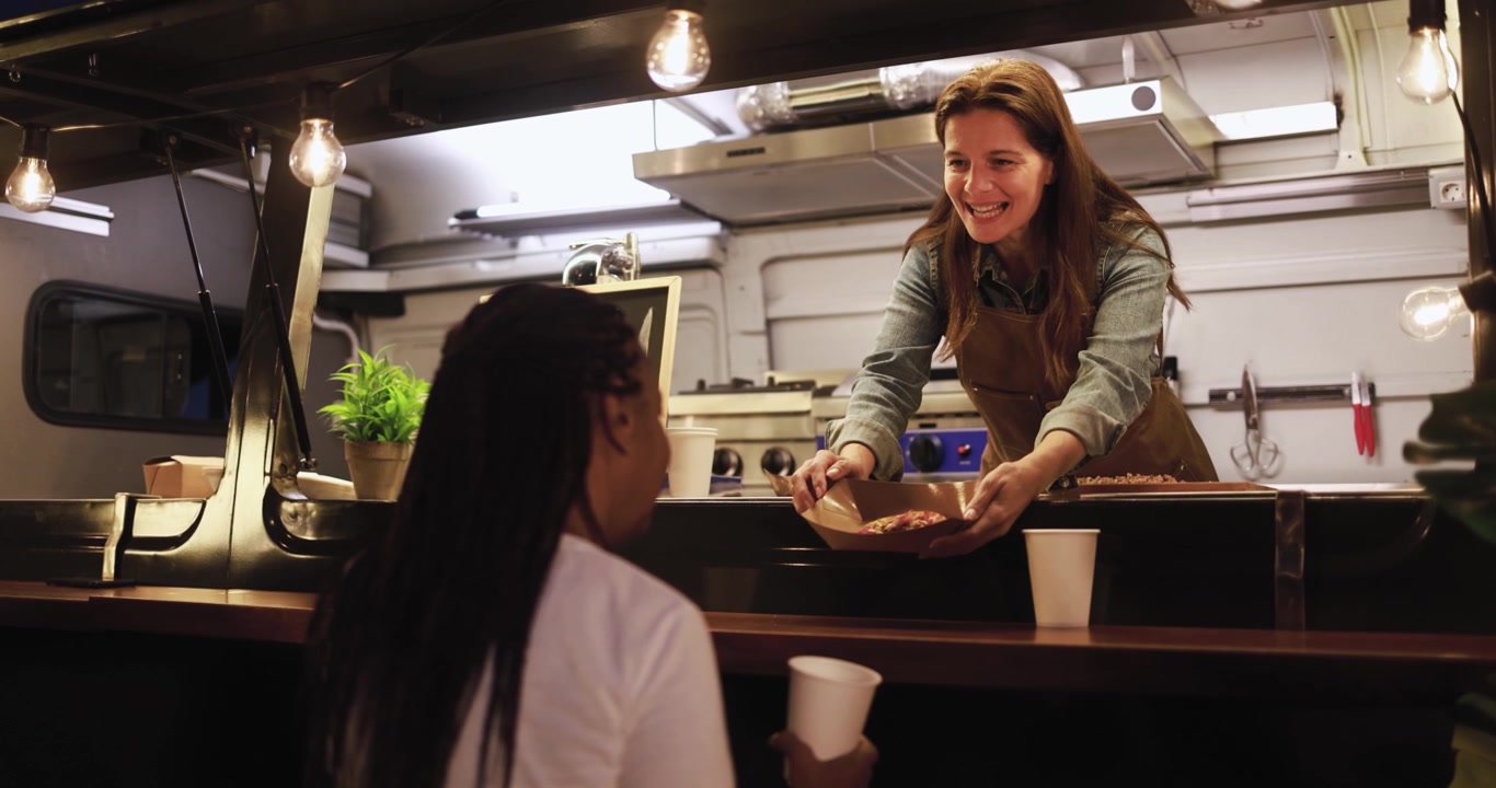 Happy Food Truck Vendor Serving Meal to Customer