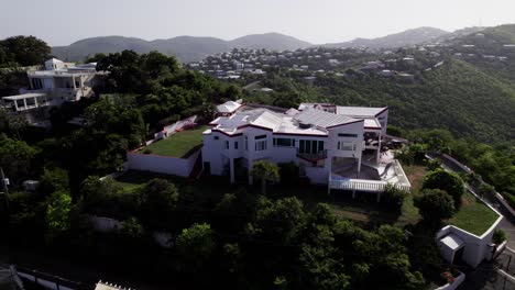 stunning aerial view on mansion house on mountain with hills in background trees forest blue sky high terrain