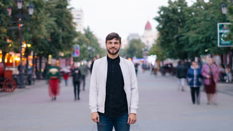 man standing on city street