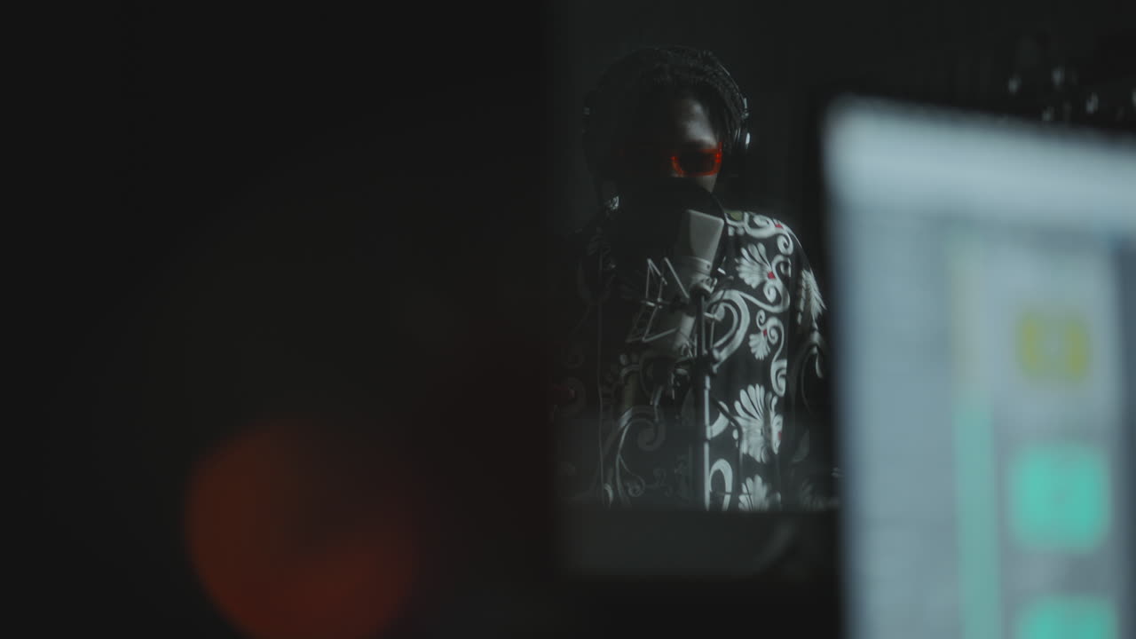Young Black Singer in Headphones Performing in Recording Booth