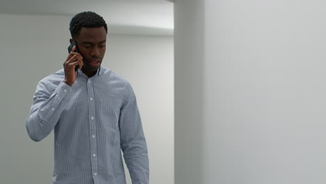 young businessman in office talking on mobile phone looking frustrated and angry