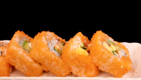 california roll sushi rotates smoothly on a white plate against a black background, with bright lighting highlighting vibrant colors and fresh ingredients