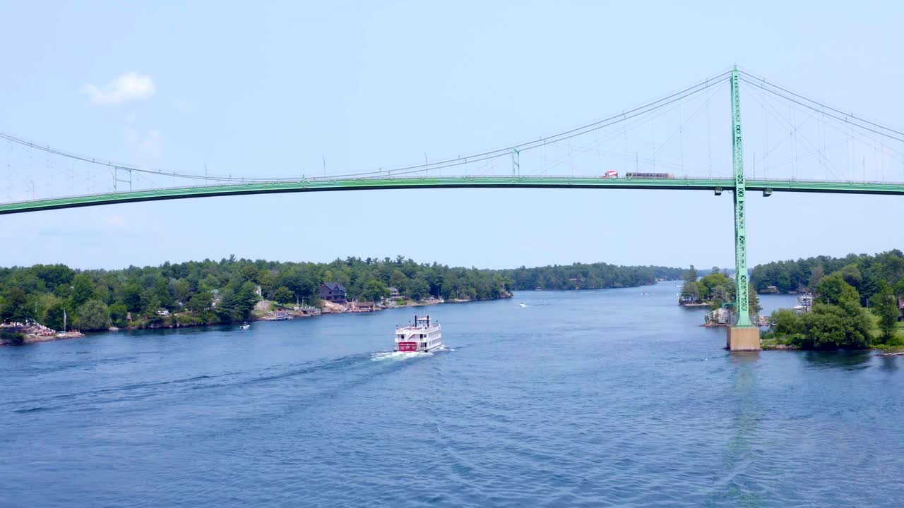 Paddle Boat Cruise Ship on St. Lawrence River Passes under the Thousand Islands in Alexandria Bay, New York - Aerial Drone View in HD and 4K