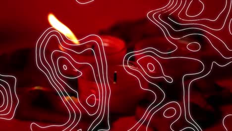 composición digital del patrón de topografía contra velas encendidas contra un fondo rojo