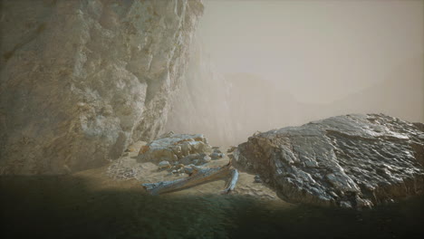rocky cliff with sand beach in deep fog