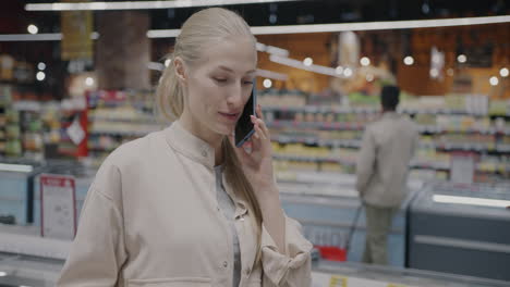 woman talking on phone in a grocery store