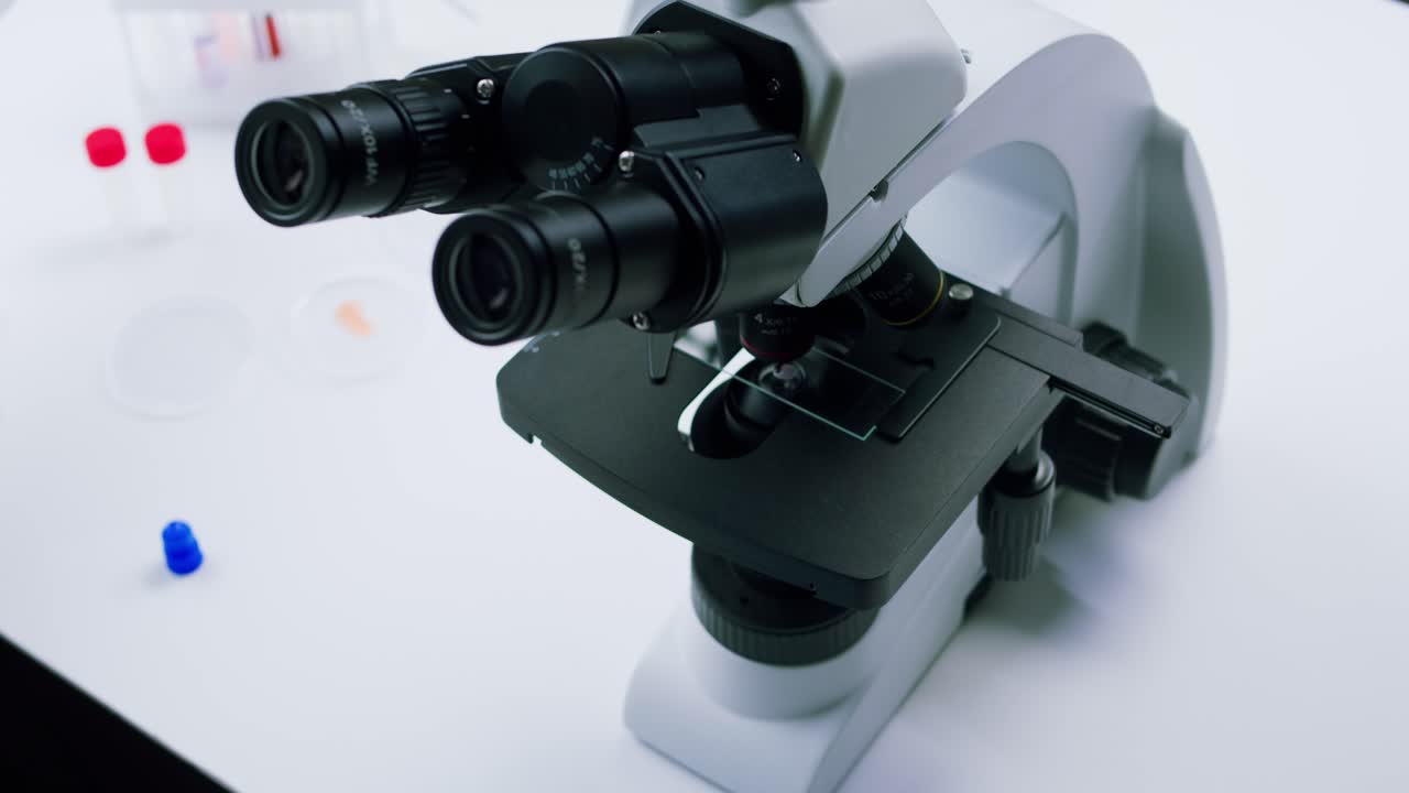 Scientist in Gloves Preparing Sample on Microscope Slide in Laboratory