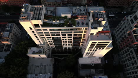 aerial view of the rooftop and sunlit side of a modern apartment, in brooklyn, ny, usa - reverse, tilt, drone shot