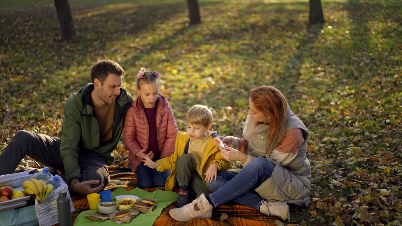 Family picnic in the park during autumn