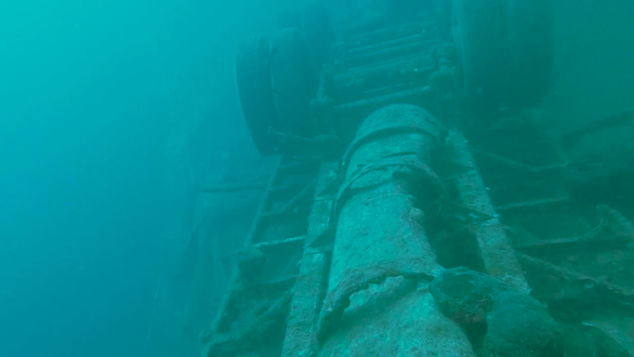 Explore the mysterious underwater world, where a sunken ship reveals stories of the past. The video captures the beauty of marine life surrounding this submerged relic