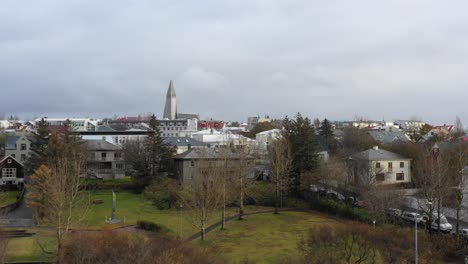 Distant-View-Of-The-Tower-Of-Hallgrímskirkja-,-A-Lutheran-Parish-Church-In-Reykjavik,-Iceland---drone-shot