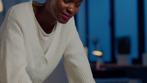 Close-up-of-business-african-woman-smiling-at-camera-after-typing-on-laptop