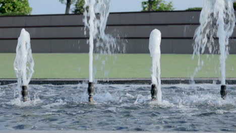 water fountains splashing water in the foreground neutral background