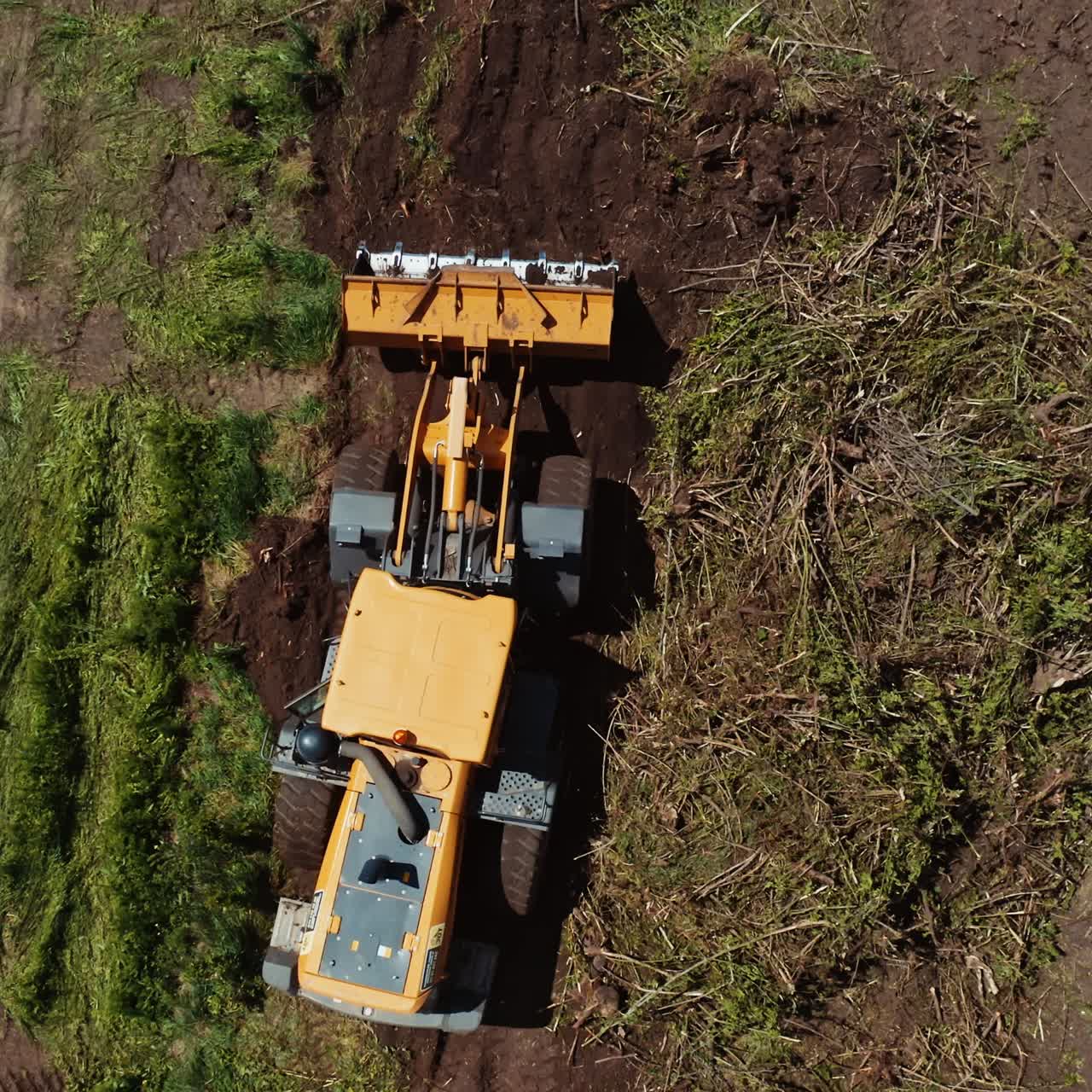 Bulldozer on countryside meadow