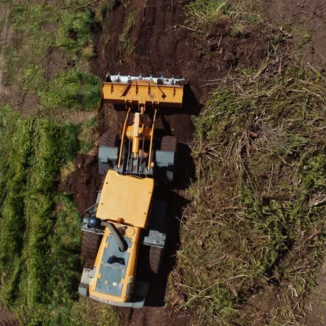 bulldozer on countryside meadow