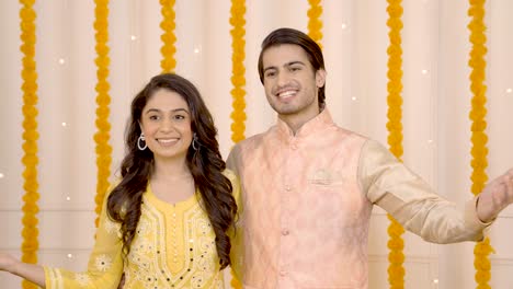 indian couple wishing happy diwali to the guests