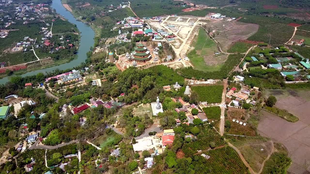 aerial circling above countryside with Buddhist monastery