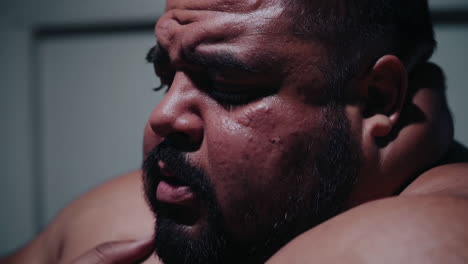 close-up portrait of a man experiencing discomfort or distress.