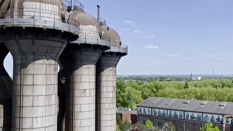 silos in industrial area in duisburg in germany from the air over the landscape park of the old steelworks