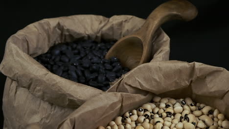 High-angle-view-of-rotating-dry-beans-in-paper-bags,-black-and-white