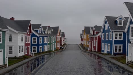rows of vibrant, colorful houses lining a wet cobblestone street, fading into the fog, create a serene and picturesque atmosphere, evoking a sense of tranquility and charm
