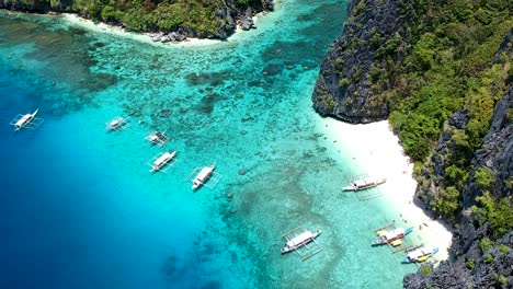 aerial of turquoise blue sea and white beach of shimizu island, el nido, palawan, philippines