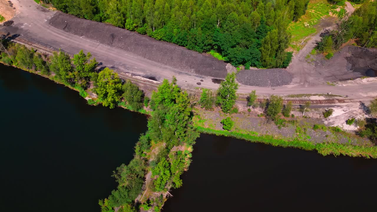 Old Industrial railway line along lakeside in post mining landscape AERIAL